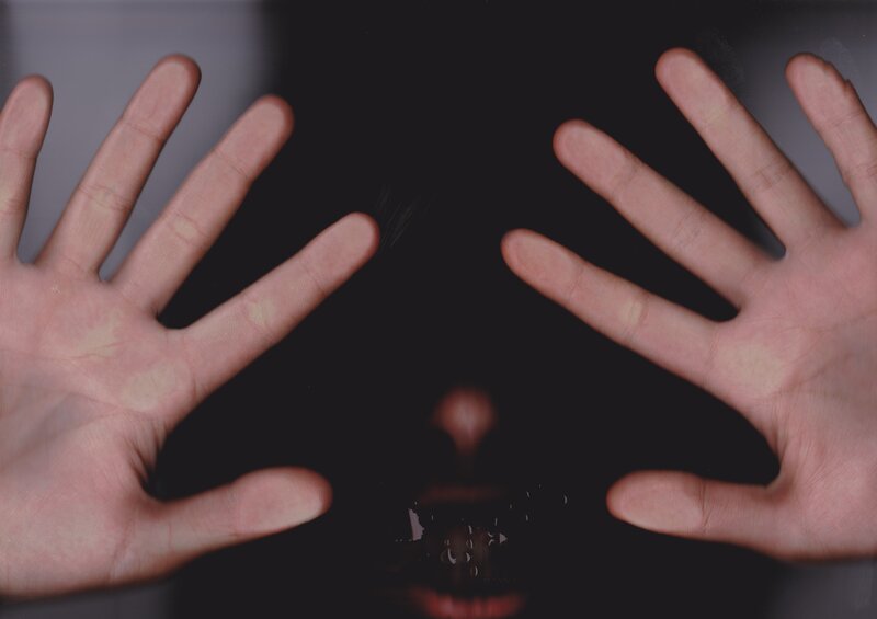 Hands covering a face