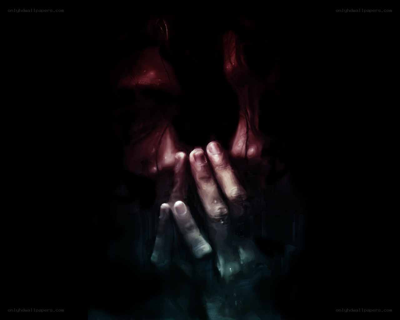 hands covering face in darkness