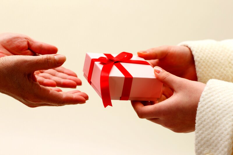 Hands Exchanging Gift Box — White