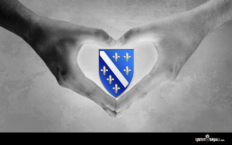 hands forming heart with coat of arms
