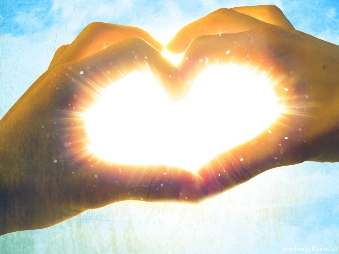 Hands forming heart with sun