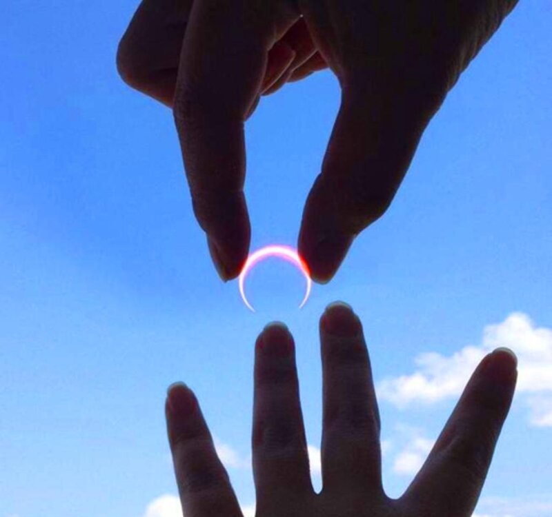 Hands Framing Solar Eclipse
