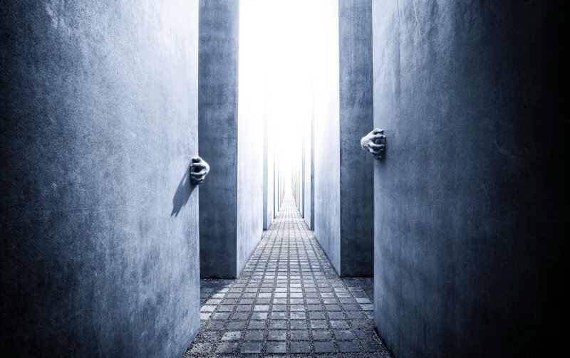 Hands Gripping Concrete Walls