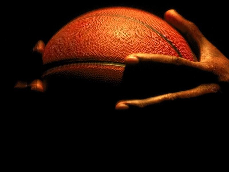 hands holding a basketball