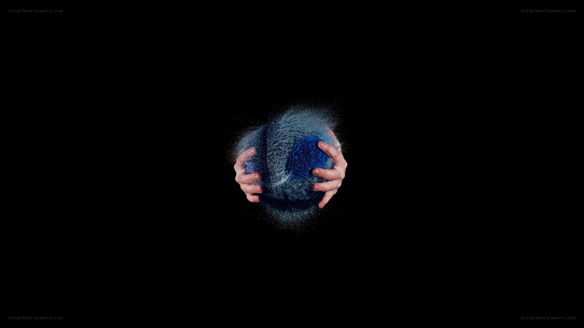 hands holding a blue sphere
