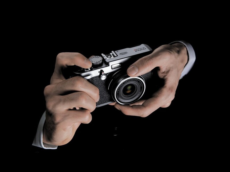 hands holding a camera