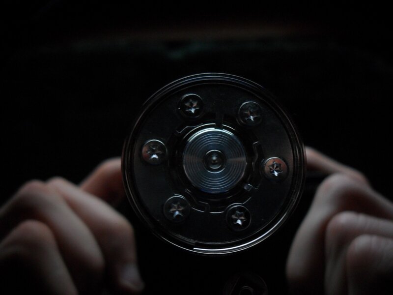 hands holding a camera lens