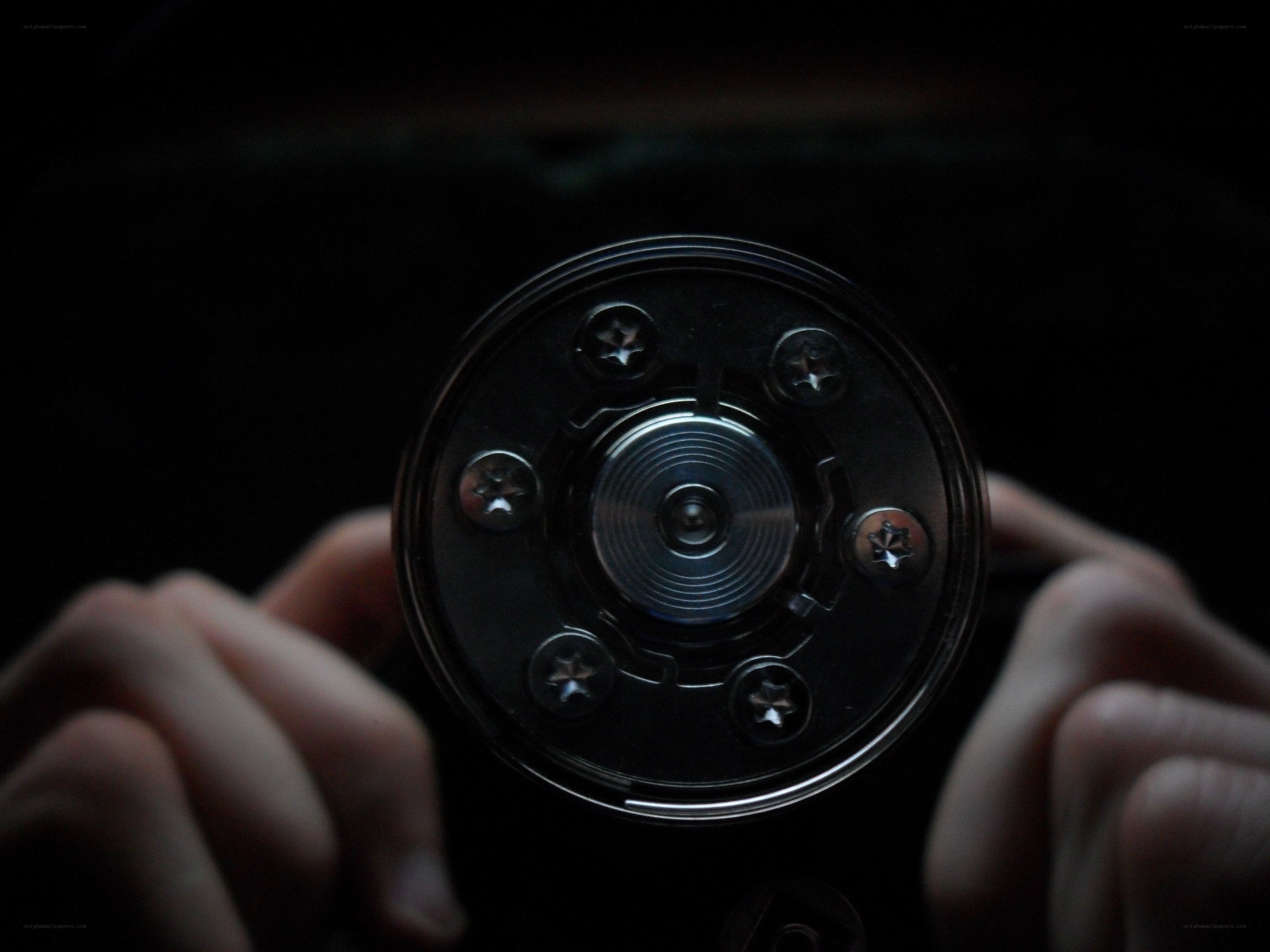 hands holding a camera lens