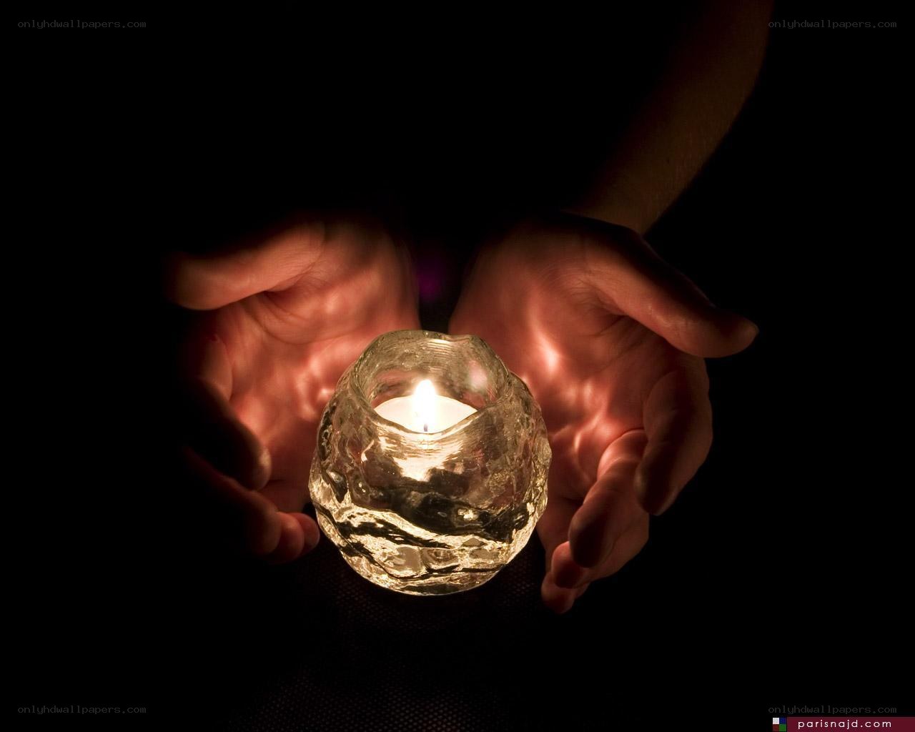 Hands holding a candle