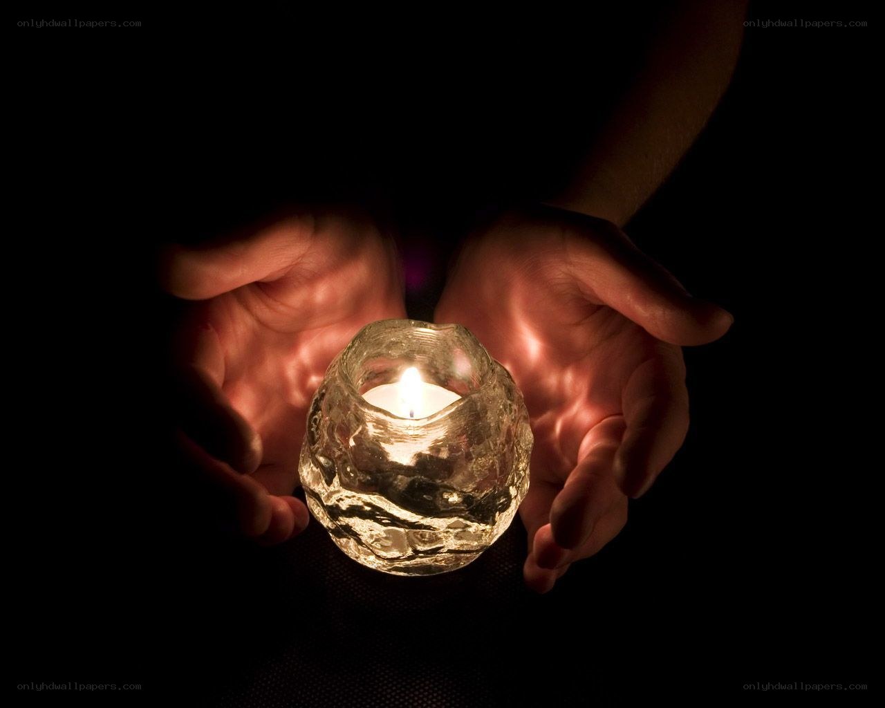 hands holding a candle