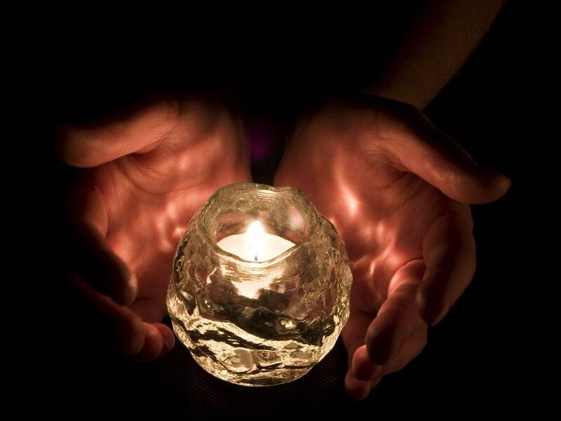 Hands holding a candle