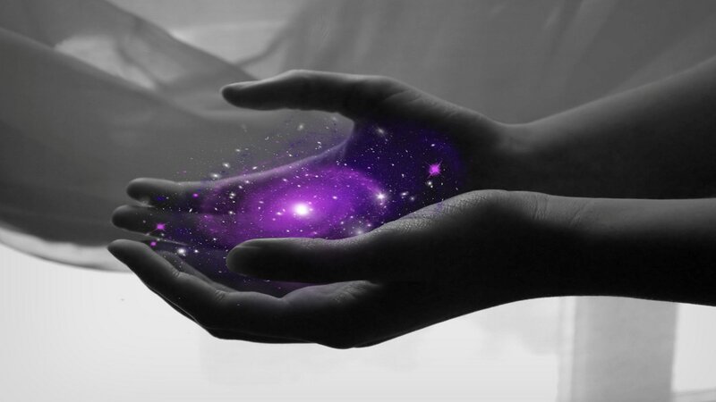 hands holding a galaxy