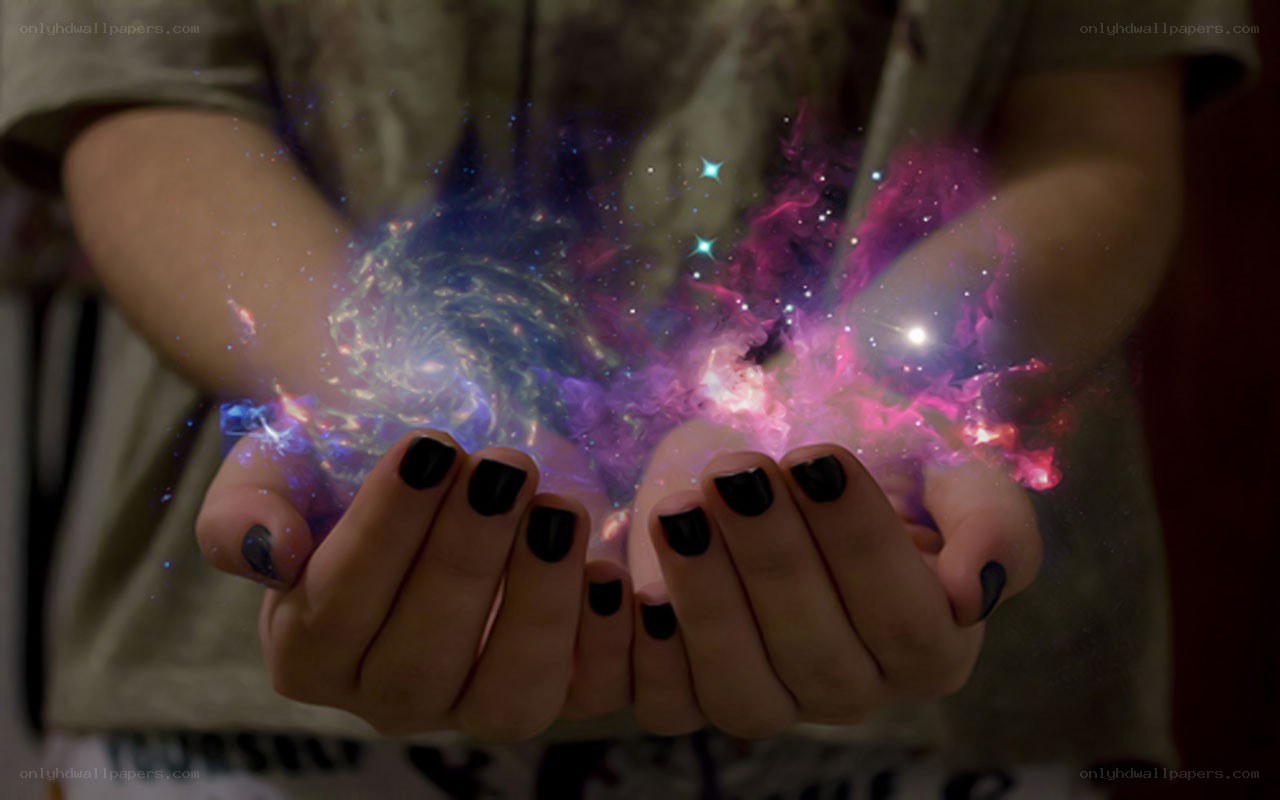 hands holding a galaxy