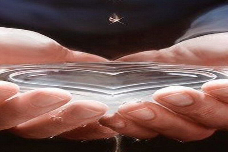 hands holding a heart of water