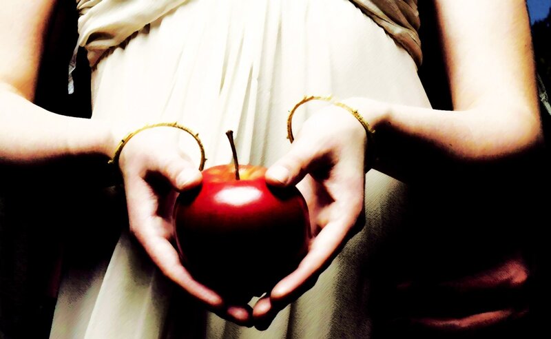 hands holding a red apple