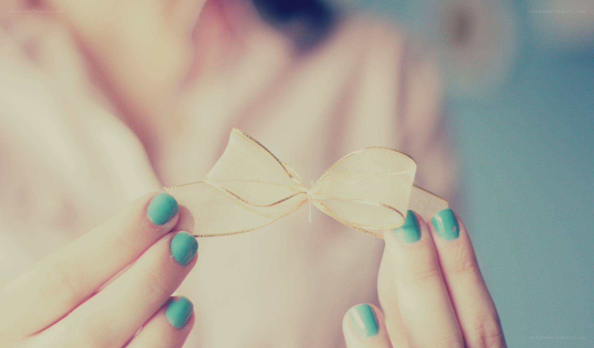 hands holding a ribbon bow
