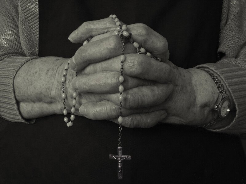 Hands holding a rosary