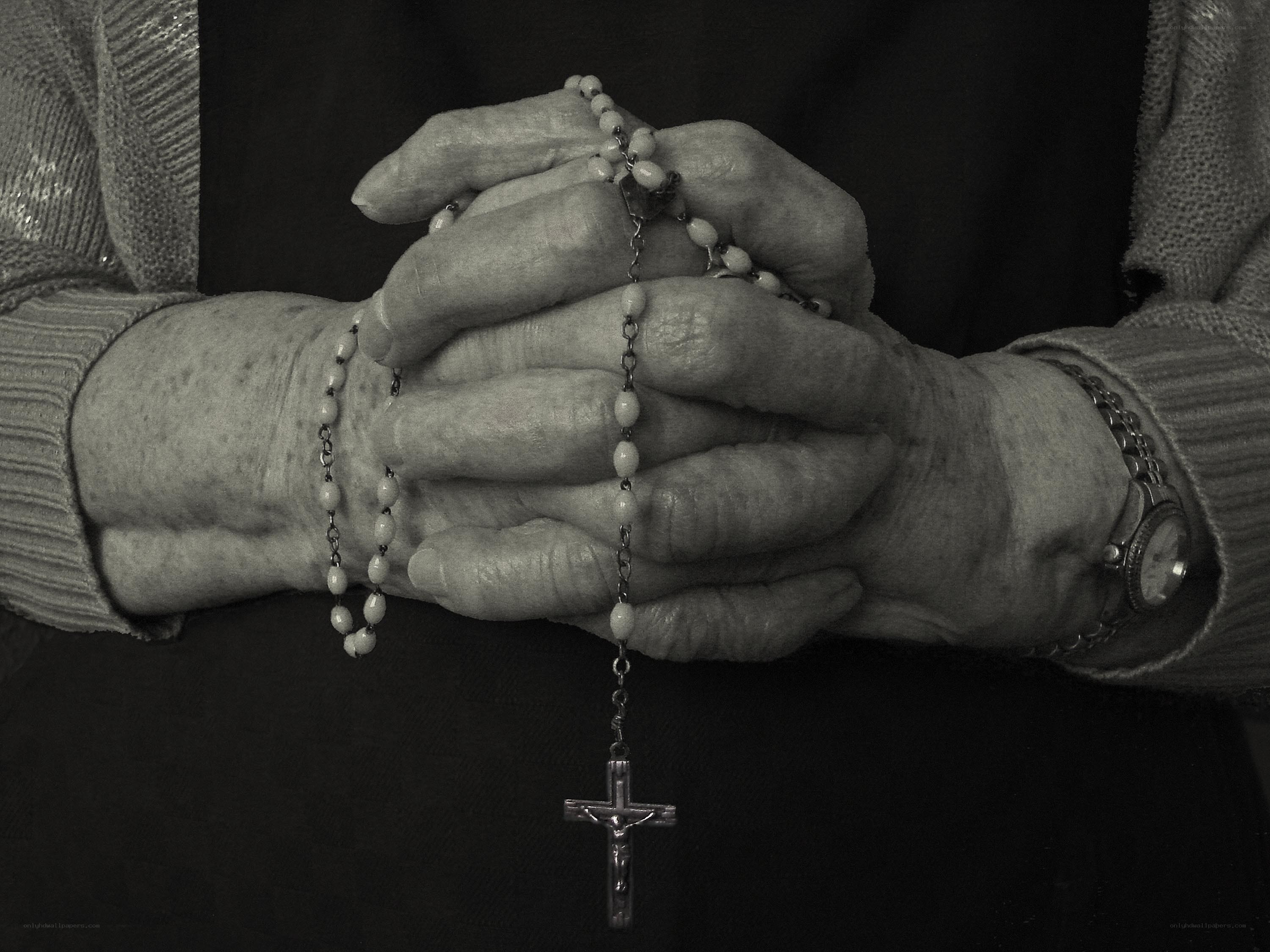 Hands holding a rosary