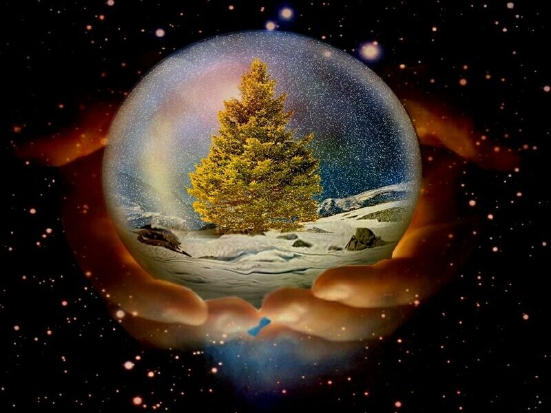 hands holding a snow globe