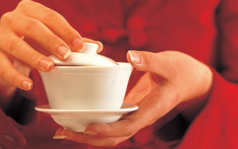 hands holding a teacup