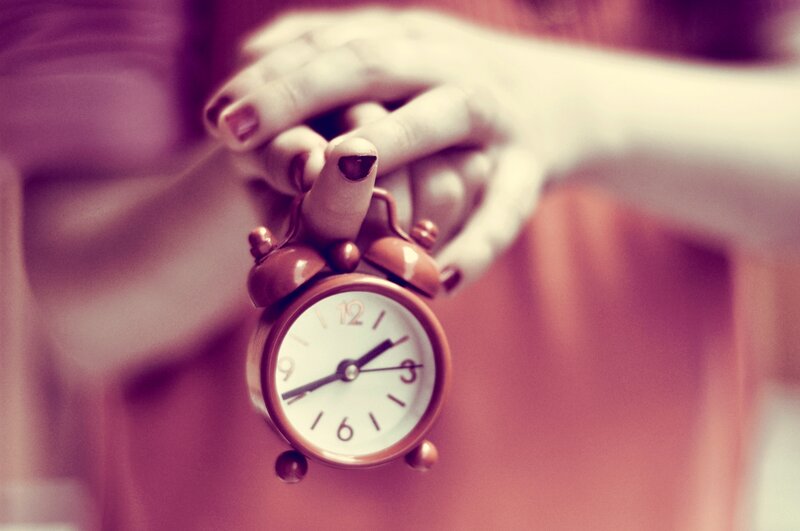 Hands Holding Alarm Clock