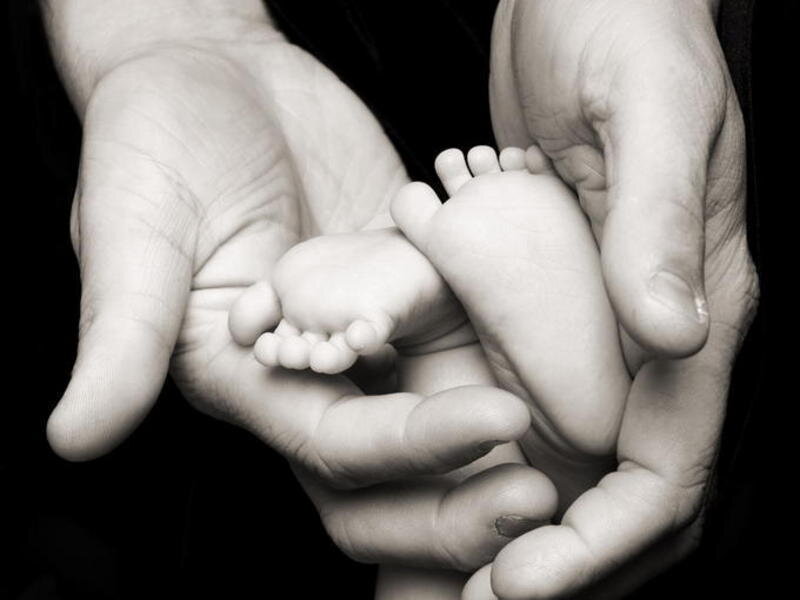 hands holding baby feet