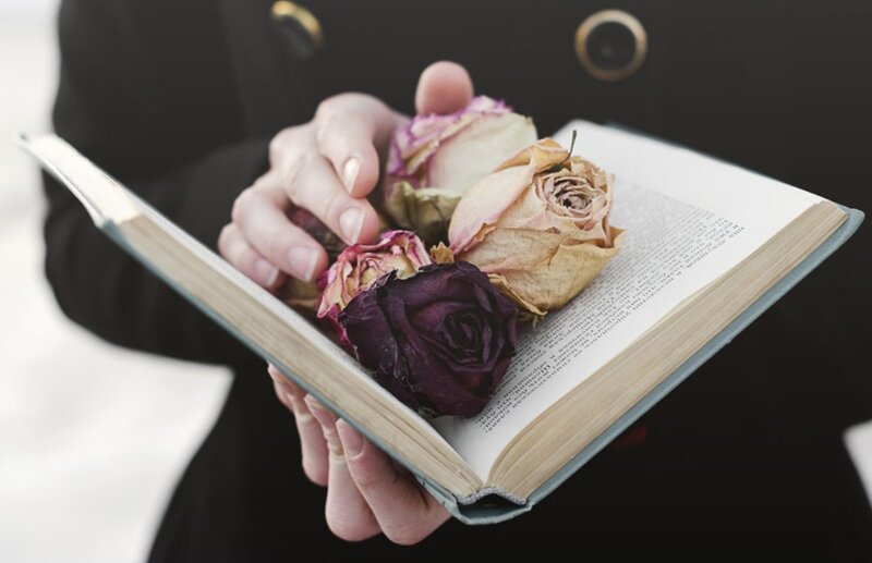 Hands Holding Book with Roses