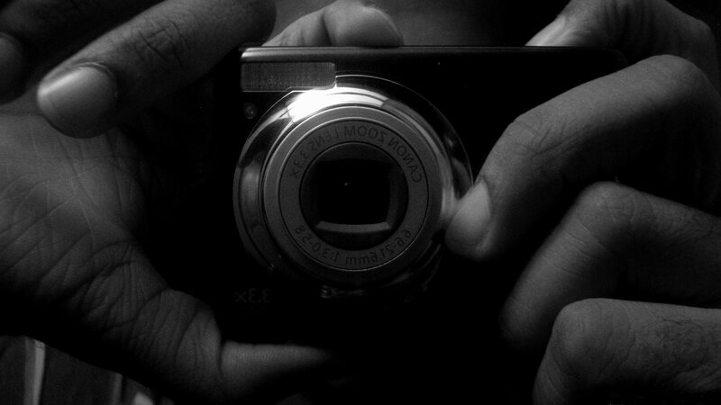 Hands Holding Camera — Black, Dramatic