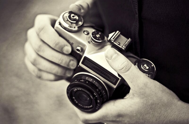Hands Holding Camera — Black
