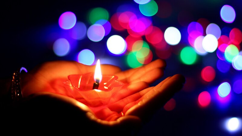 Hands Holding Candle — Red