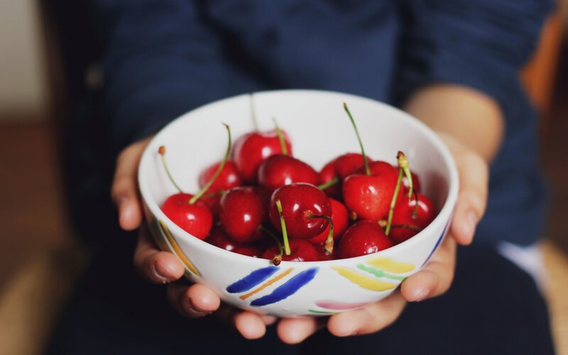 Hands Holding Cherries — Red
