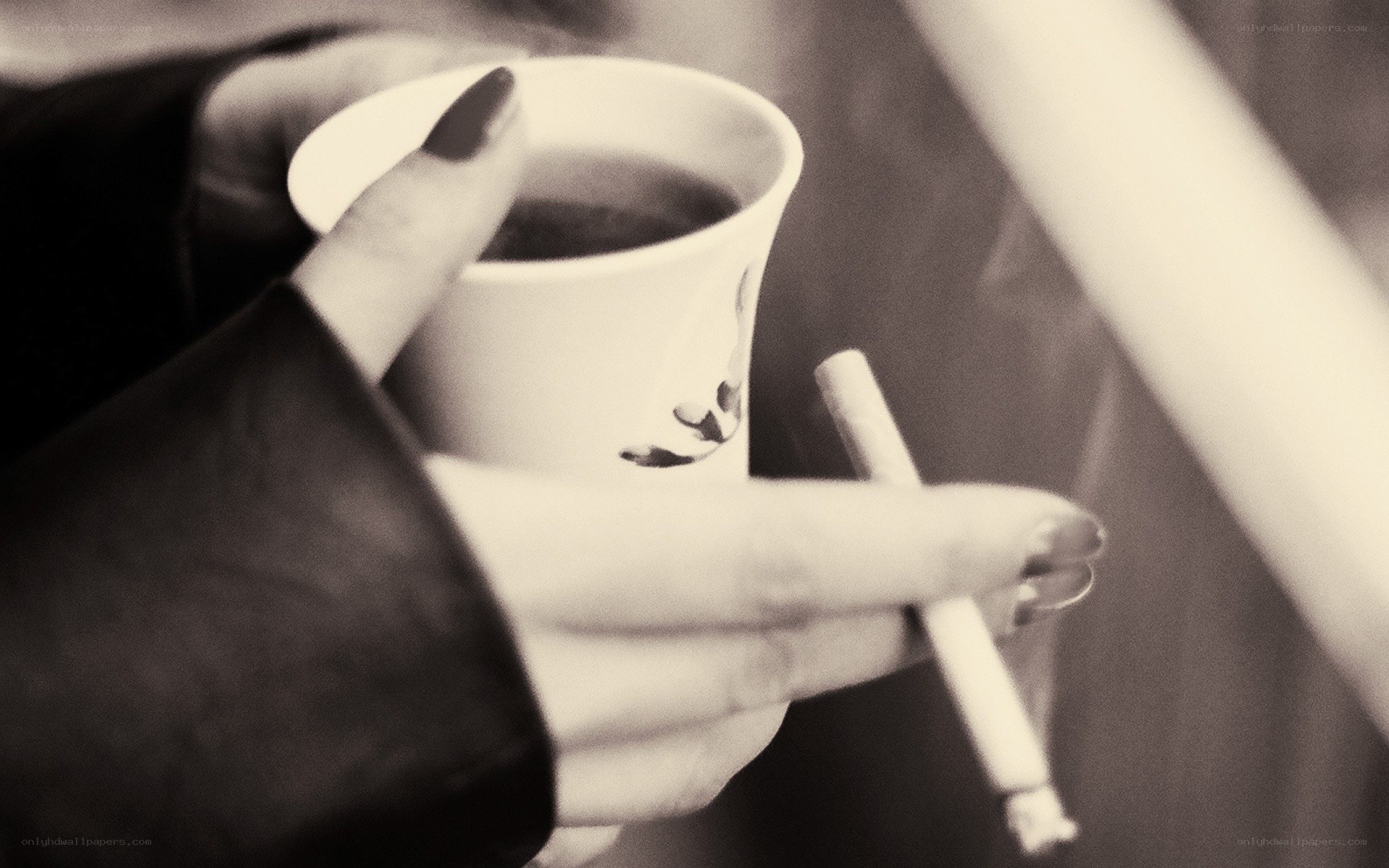 hands holding coffee and cigarette