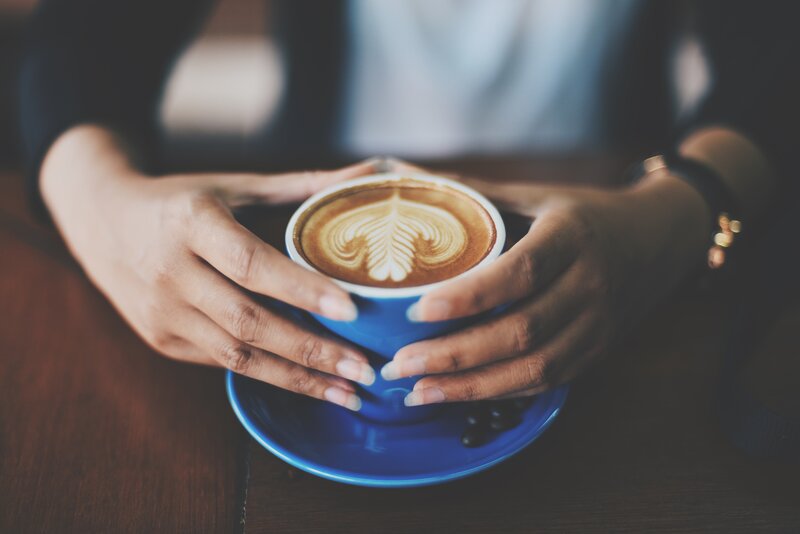Hands holding coffee cup