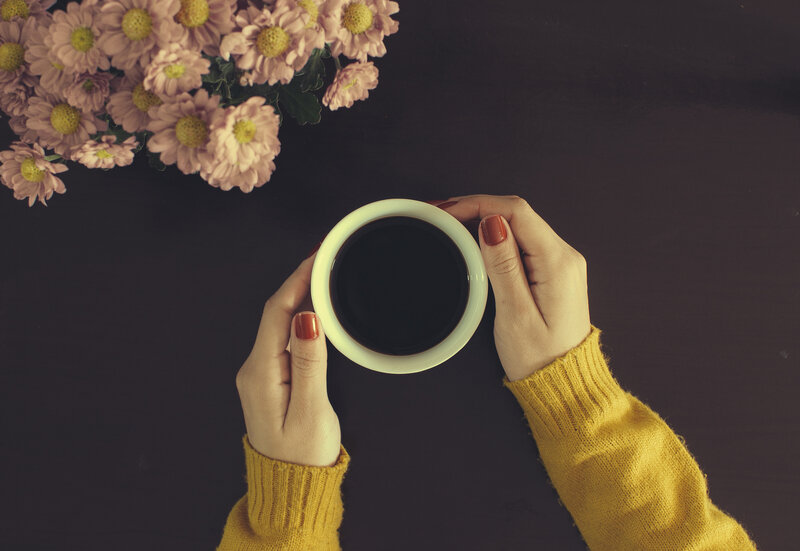 Hands Holding Coffee Cup — Yellow