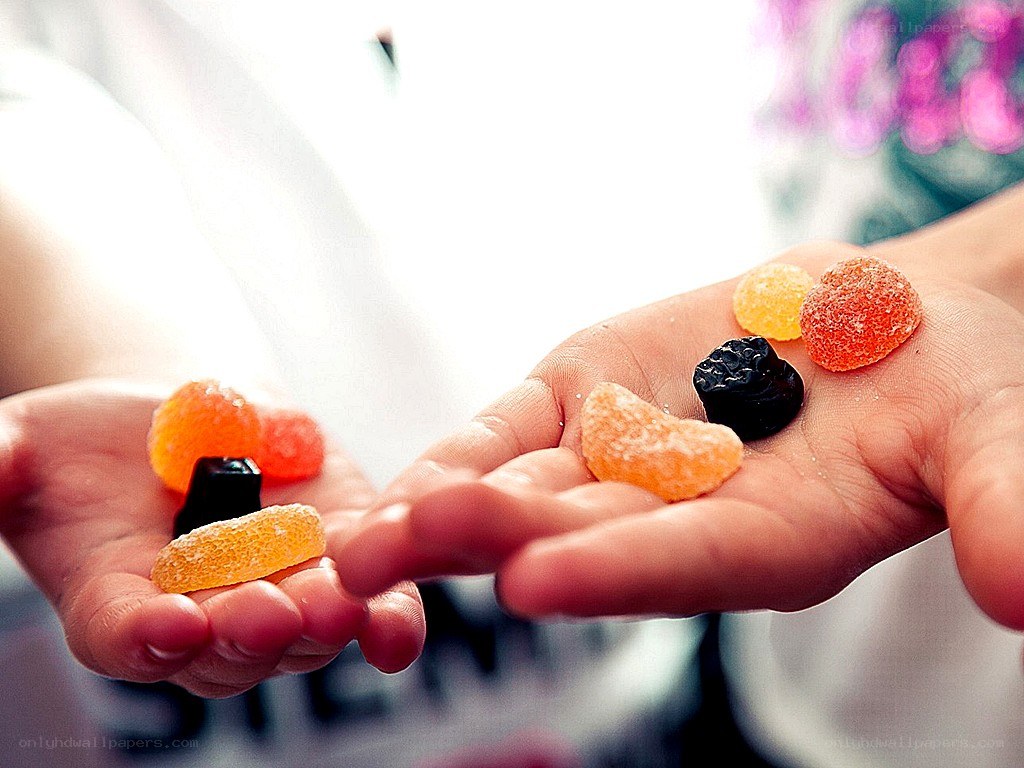 hands holding colorful candies