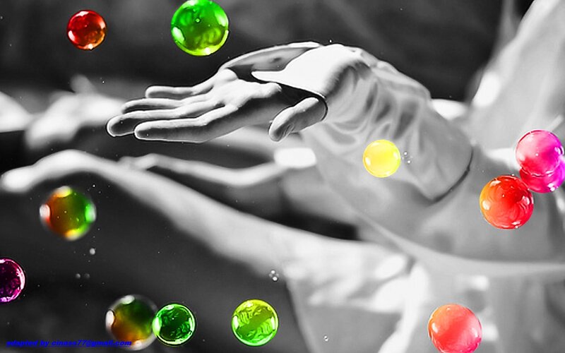 Hands Holding Colorful Orbs