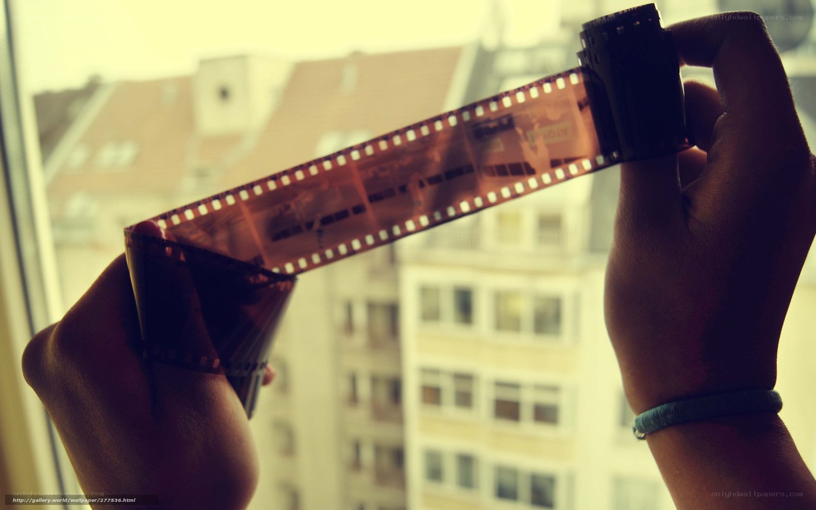 hands holding film strip