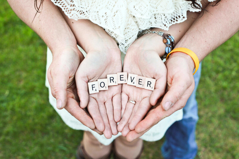 Hands holding 'FOREVER' tiles