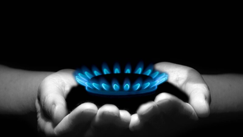 hands holding gas flame