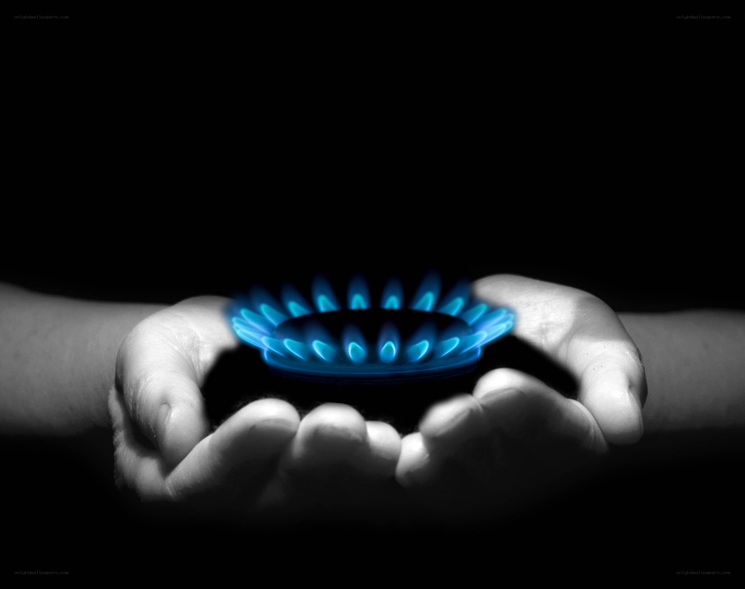 hands holding gas flame