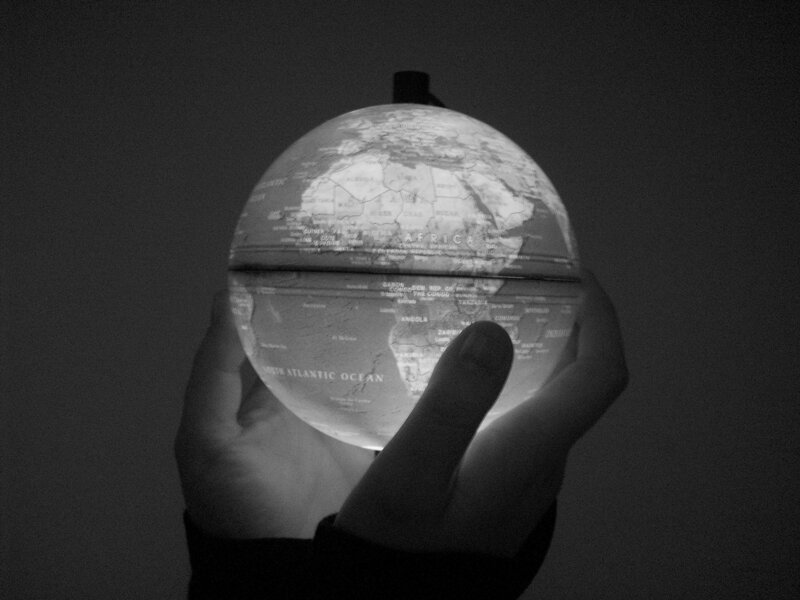 Hands Holding Globe — Black