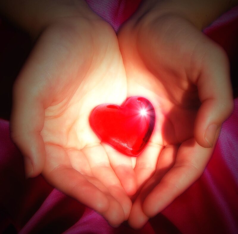 hands holding glowing heart