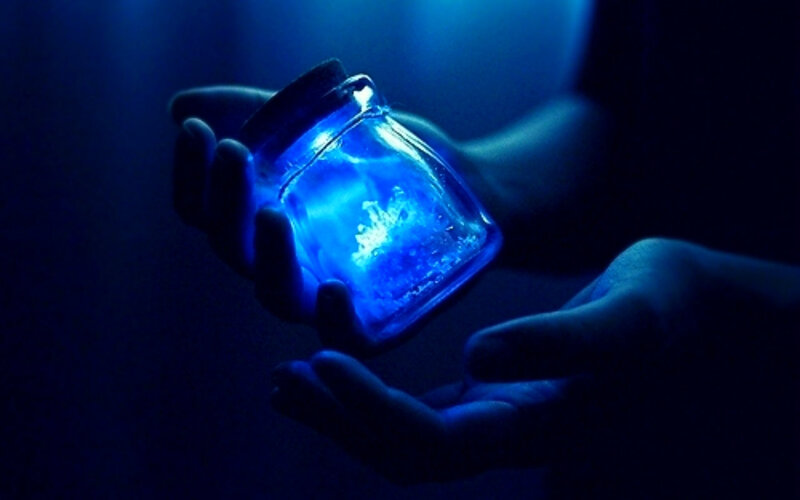 Hands Holding Glowing Jar