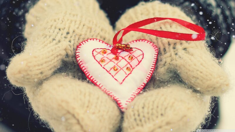 hands holding heart ornament
