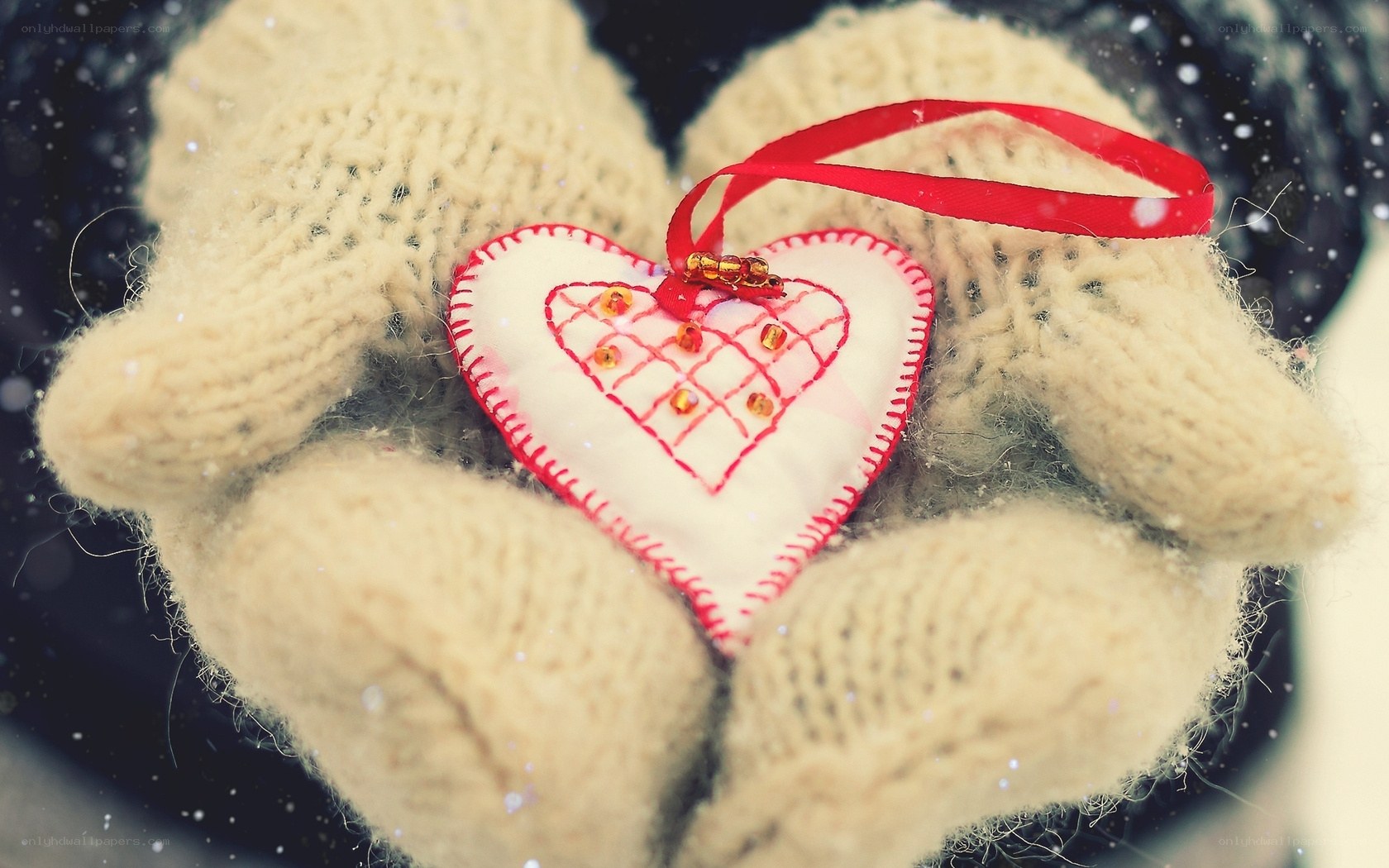 hands holding heart ornament