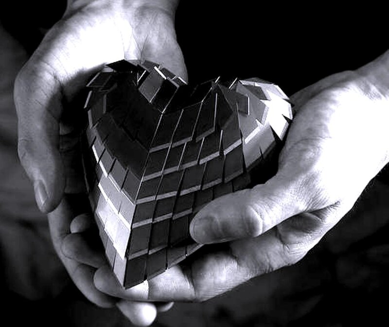 Hands Holding Heart Sculpture