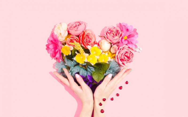 Hands Holding Heart-shaped Flowers