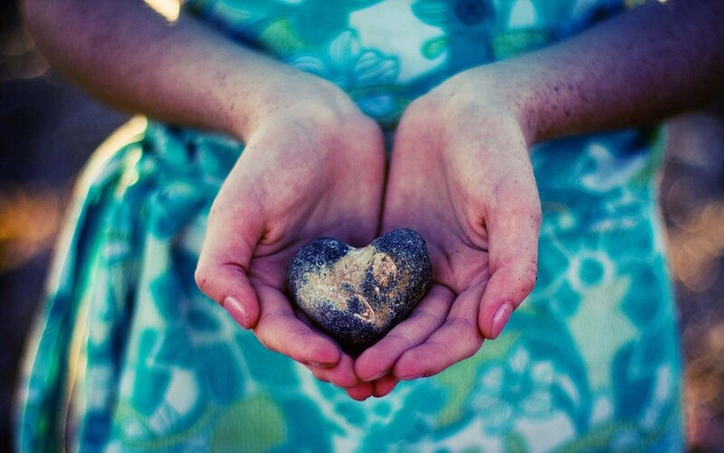 Hands Holding Heart-shaped Stone — Blue
