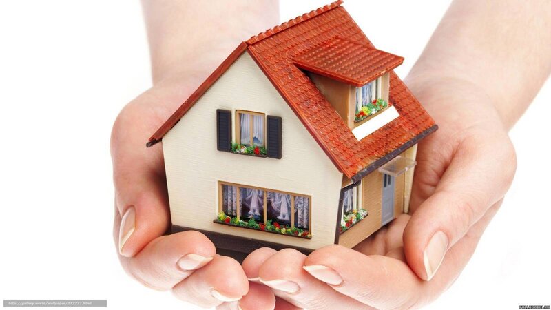hands holding house model