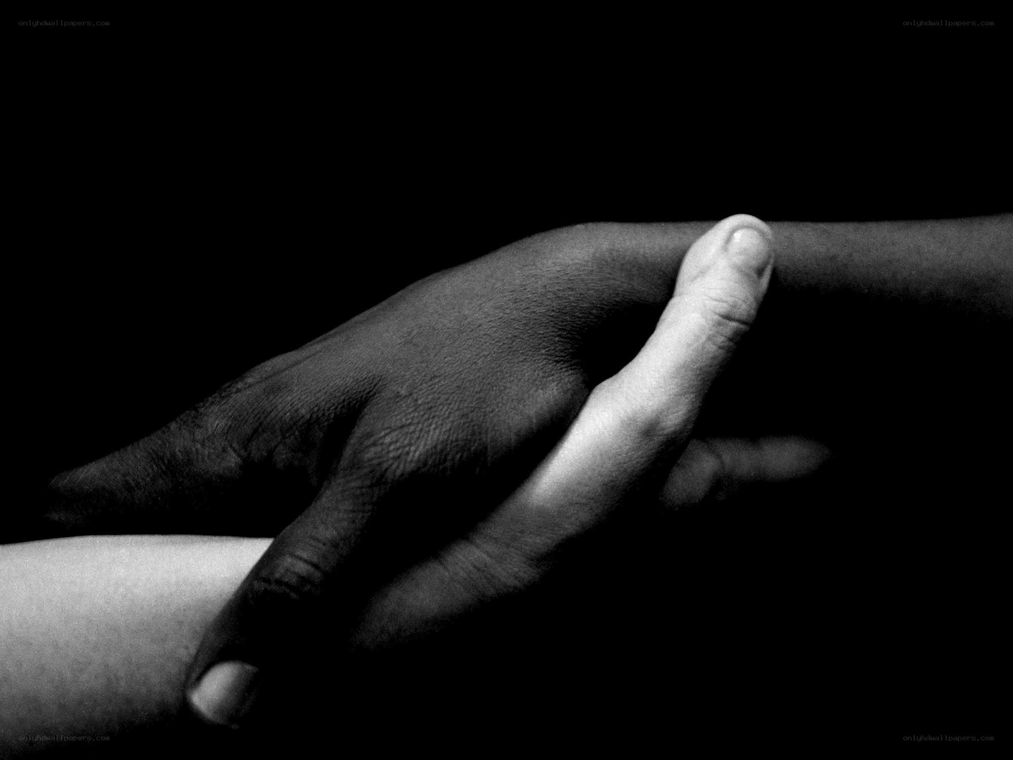 hands holding in darkness